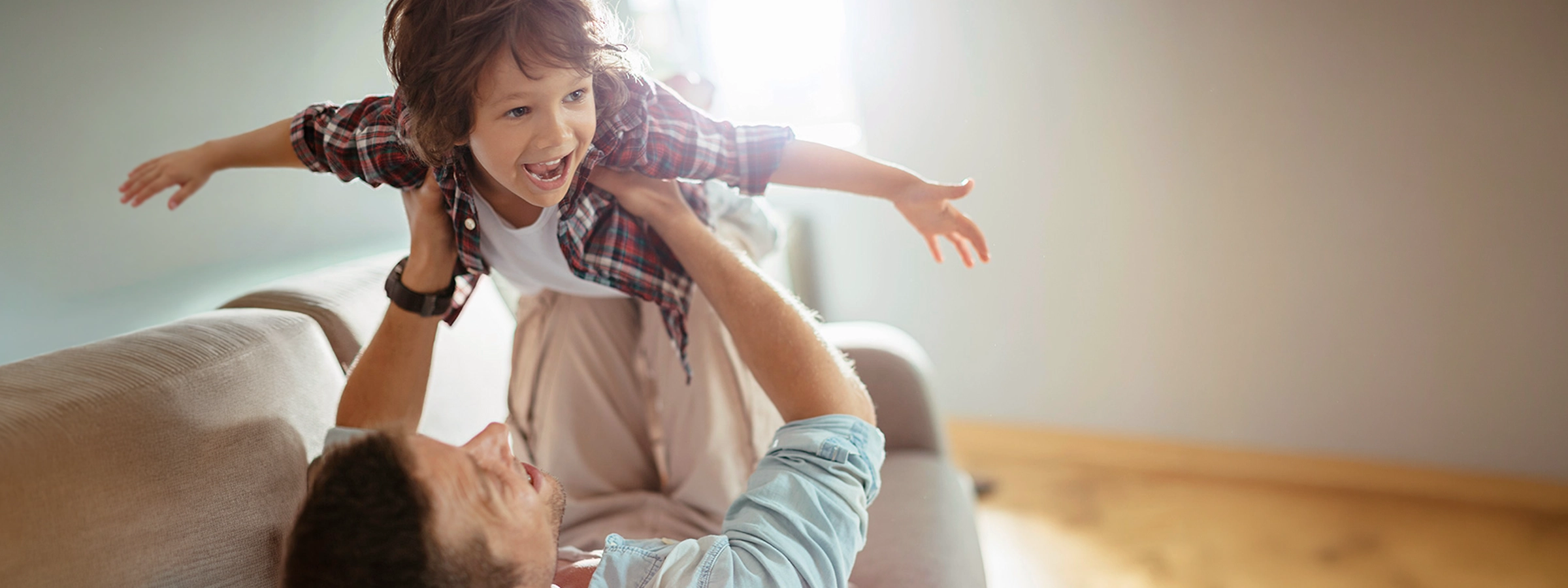Parent and child sharing a joyful moment of play together